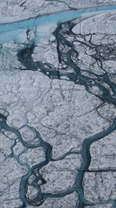 A 5- to 10-meter stream of meltwater flows on the Greenland icecap. 